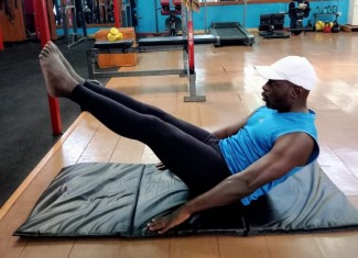Sammy Ombisa exercising as part of recovery process. Pilates exercise to support recovery.